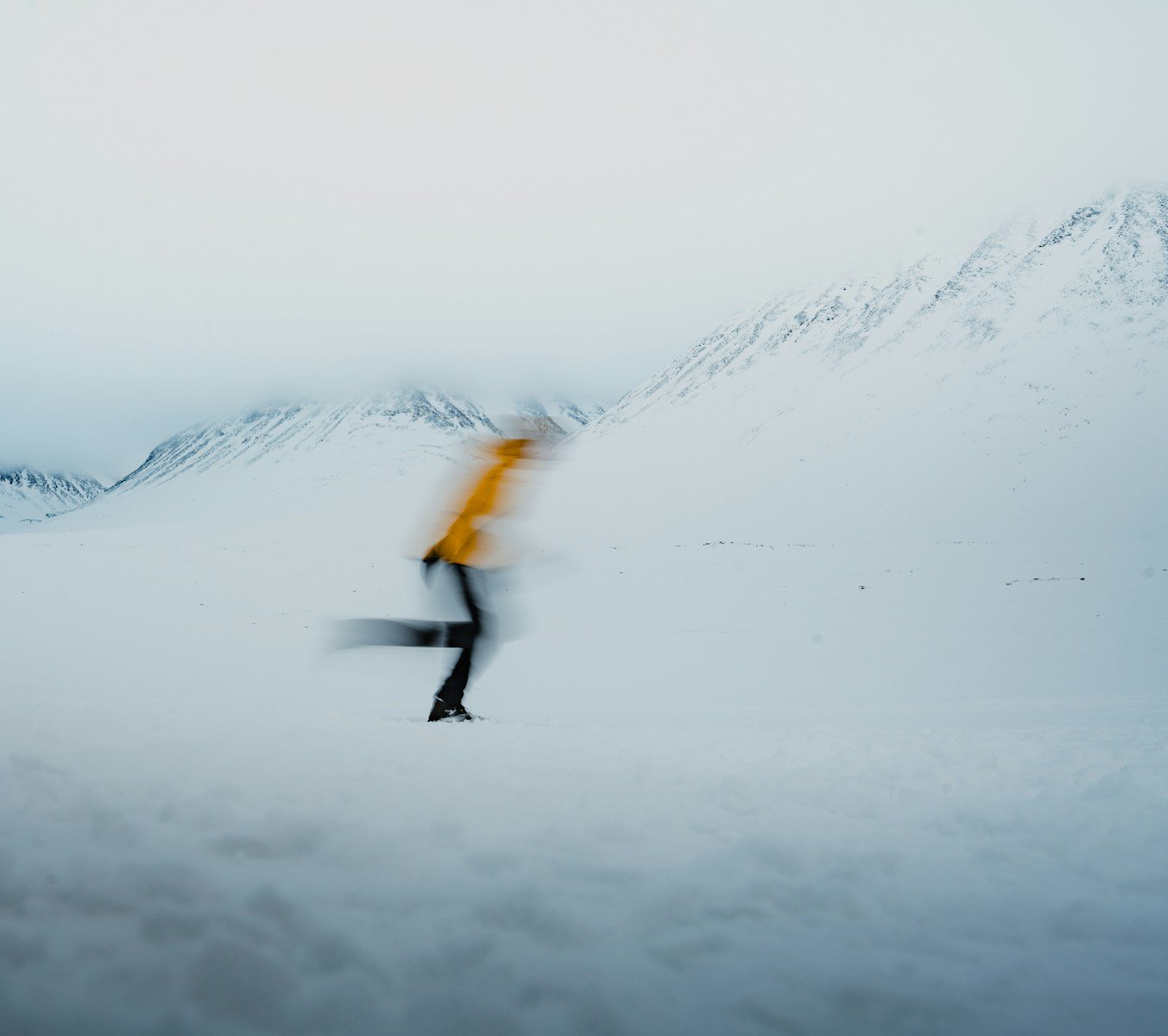 A blurry photo of a person walking in the snow