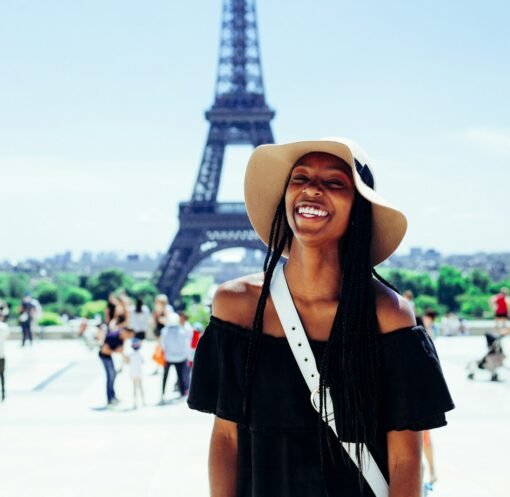 woman standing behind Eiffel Tower during daytime