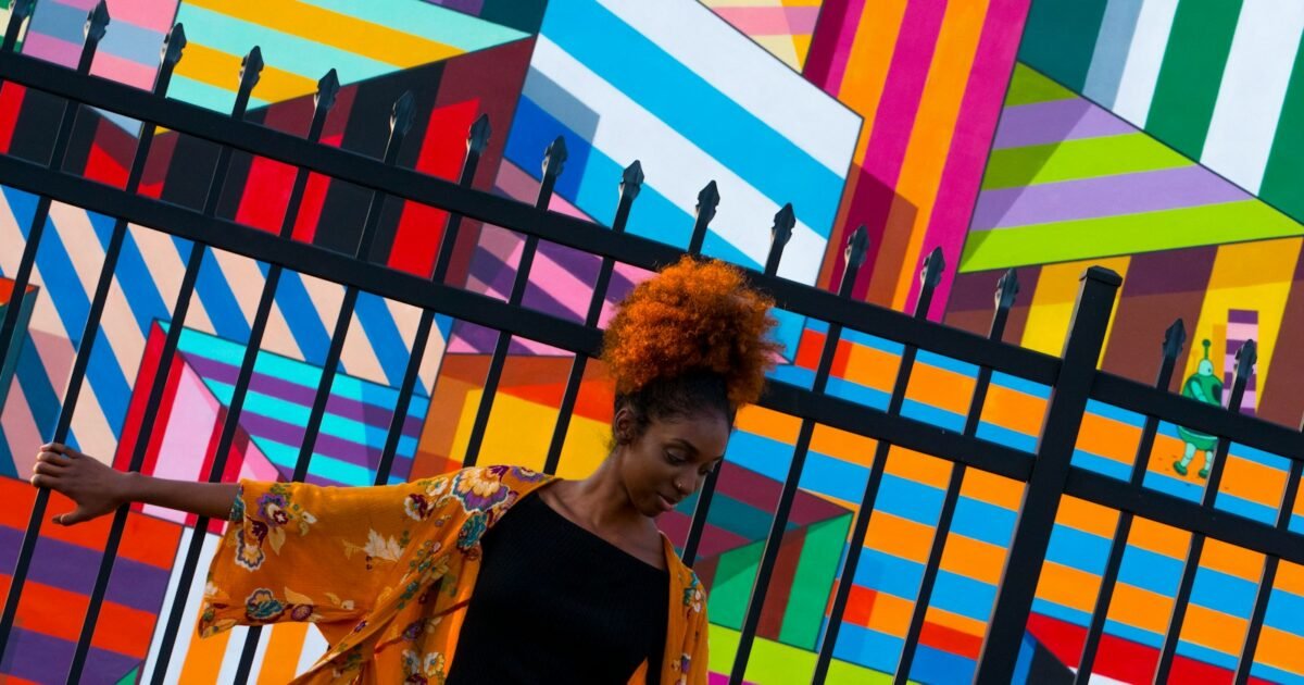 woman standing in front of black gate